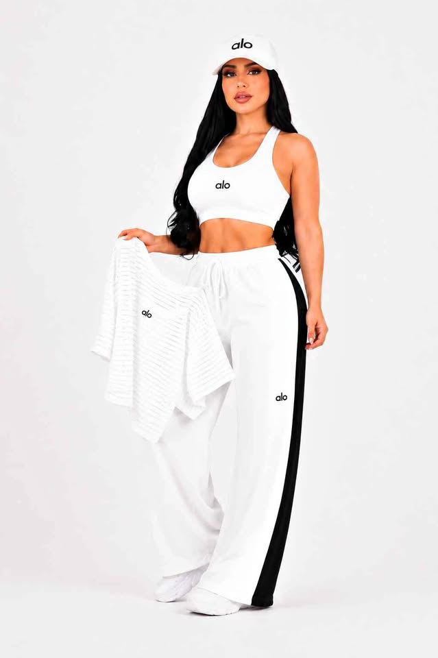 Model wearing a white cropped top and wide-leg pants